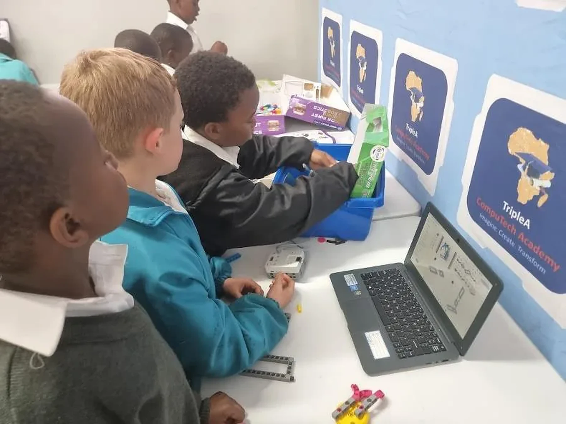 Young learners using computers during a TripleA programme