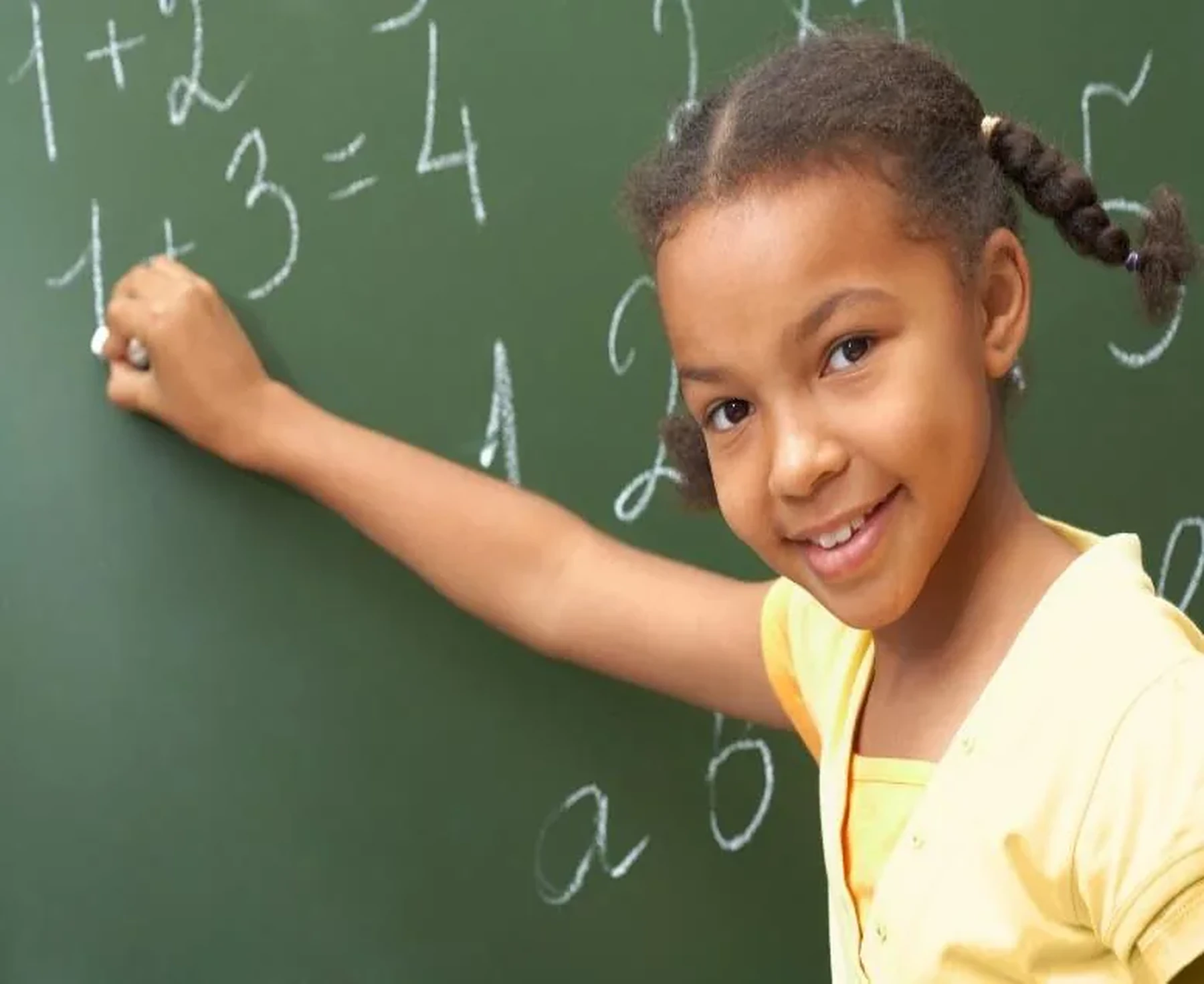Learner working on mathematics at a chalkboard